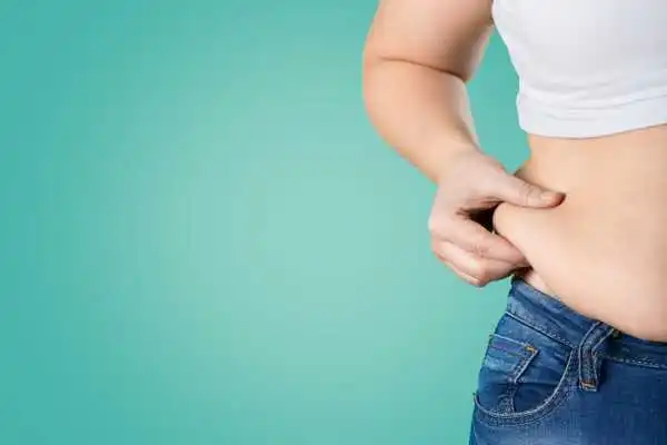 Image of woman pinching her love handles to show weight gain Cribbs Causeway